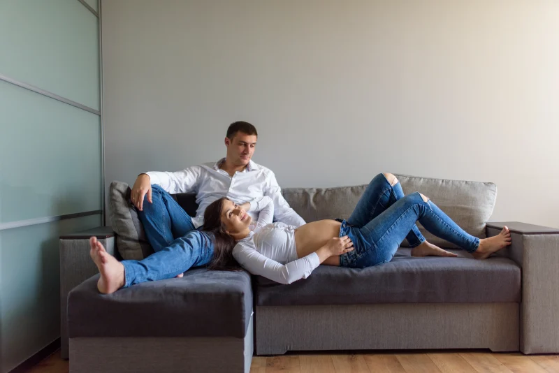 Pareja descansando en el sof&aacute; de su casa
